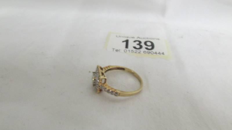 A diamond ring in a square design with princess cut stones and round cut stones in 9ct gold. size R. - Image 2 of 2