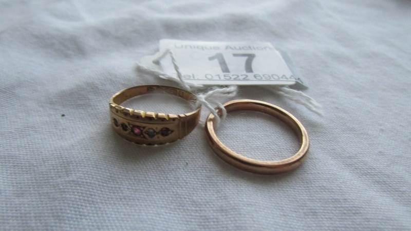A 9ct gold wedding ring, size L and an early 20th century ring (missing one stone), size J half.