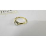 A solitaire diamond ring mounted in 18ct gold and platinum. size L.