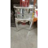 A good quality silver coloured mirrored cabinet.