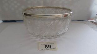 A silver rimmed cut glass bowl.