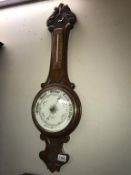 A Victorian mahogany Barometer with porcelain dial and carved case Height 85cm (COLLECT ONLY)