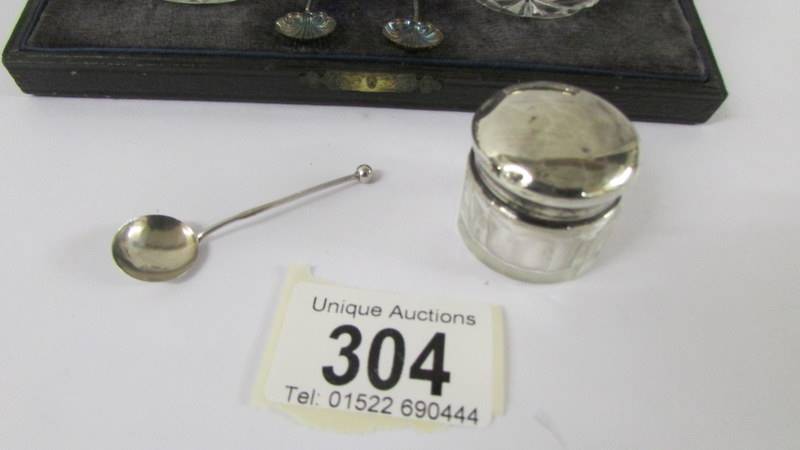 A cased pair of silver rimmed salts with spoons, a silver lidded pill box and a silver mustard - Image 3 of 3