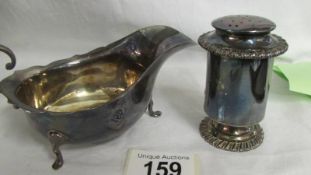 A silver sauce boat and a silver pepperette, approximately 180 grams.