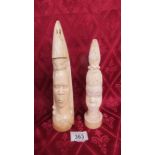 Two antique ivory carved tribal head figures. Heights 27.25cm & 23cm.