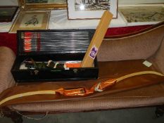 A Pro Hoyt one piece recurved long bow and a case of arrows, Fletchers, Tuli, books etc., Collect