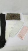 A vintage evening bag and four pairs of ladies gloves including kid. All pieces in good condition.