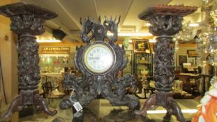 An intricately carved three piece clock garniture with dragons. Collect only.