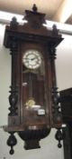 A Vienna wall clock with art nouveau painted side panels Height 93cm