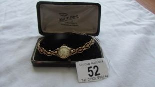 An Accurist gold ladies wrist watch. Bracelet hallmarked, case hallmarked, watch is wound to it's