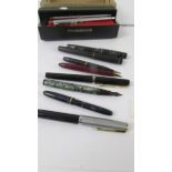 Eight vintage pens and a Papermate pen set.