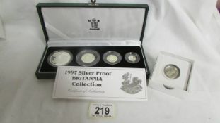 A UK Britannia silver proof collection and a 1983 silver proof £1 coin.