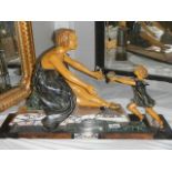 A deco figure of a mother with child. Collect only.