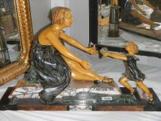 A deco figure of a mother with child. Collect only.