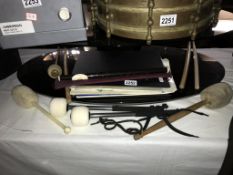 A folder of drum/brass song books & drum sticks