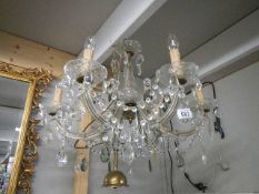 A six lamp glass chandelier, 68cm diameter by 55 cm drop. Collect only.