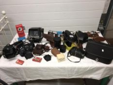 A quantity of vintage cameras etc.