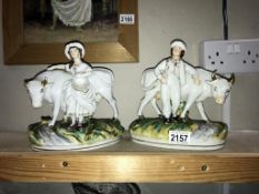 A pair of Staffordshire pottery milk maid & boy with cow figures - both A/F (Thomas Parr)