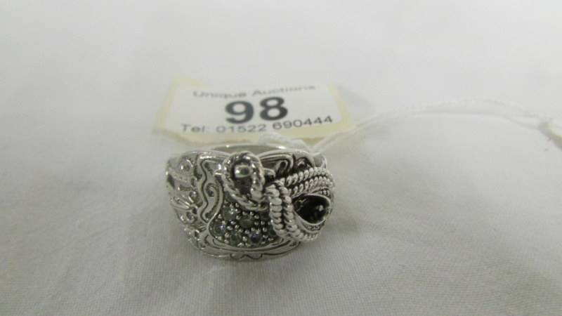 A sterling silver saddle ring set zirconia stones, size V. - Image 3 of 4