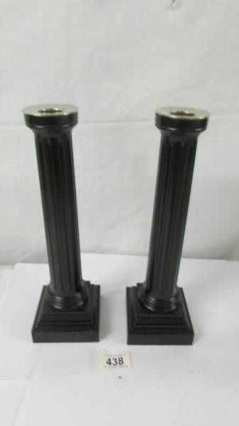 A pair of David Linley dark wood Garnick candlesticks.