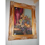 A good gilt framed and glazed floral embroidery.