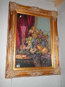 A good gilt framed and glazed floral embroidery.