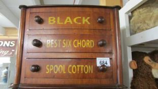 A small three drawer advertising chest.