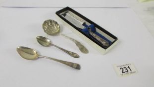 A silver handled knife, silver sifter spoons and two silver teaspoons.