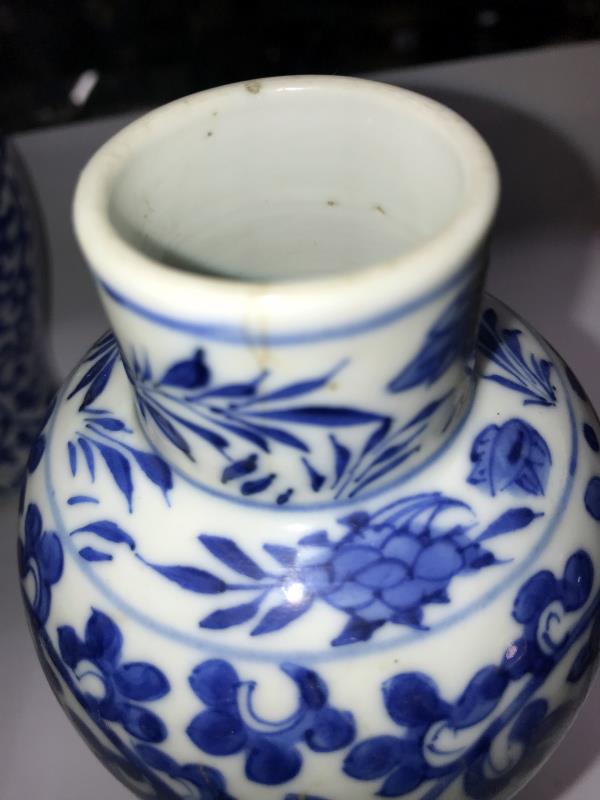 A pair of early Chinese blue and white lidded vases (both lids a/f) and a blue and white flask. - Image 15 of 25