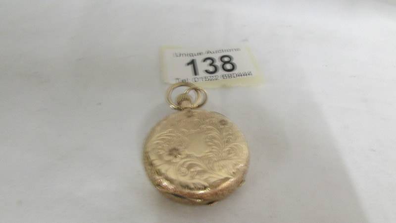 A 14ct gold fob watch with chased gold work. Wound to limit, diameter 34mm, weight 34.8g - Image 2 of 2