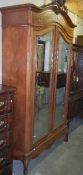 A good French two door armoire with mirrored doors.