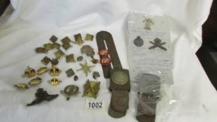A mixed lot of military badges and buttons.