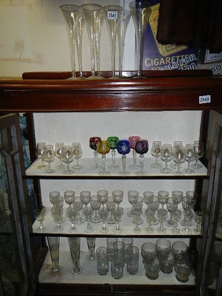 Three shelves of glass including coloured and overlaid.