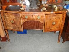A good mahogany bow front sideboard with two cupboards, centre drawer and lower tamber front.