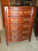 A good 5 drawer French chest on Queen Anne legs with shaped brass handles.