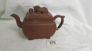 A Chinese earthenware teapot with dog of foo knob to lid. A/F