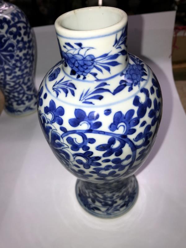 A pair of early Chinese blue and white lidded vases (both lids a/f) and a blue and white flask. - Image 16 of 25