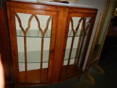 A mahogany 2 door bow front cabinet in good condition.