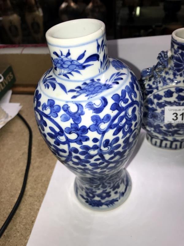 A pair of early Chinese blue and white lidded vases (both lids a/f) and a blue and white flask. - Image 20 of 25