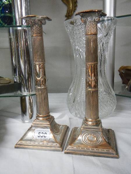 A pair of silver plate Corinthian column candlesticks, 31 cm tall.