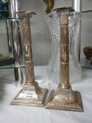 A pair of silver plate Corinthian column candlesticks, 31 cm tall.