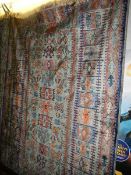 A blue and greem silk 'Middle Eastern' angular/symmetrical pattern rug, (made in Belgium) 205 x