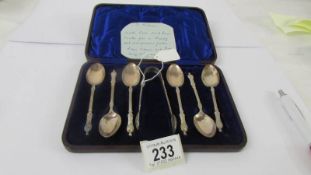 A cased set of six silver apostle spoons with sugar tongs.