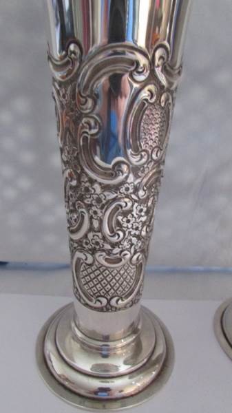 A pair of silver embossed vases. - Image 2 of 4