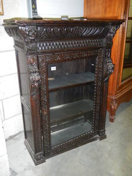 A good heavily carved glazed door book case,