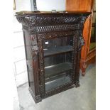 A good heavily carved glazed door book case,