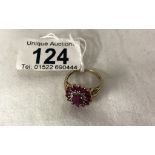 A yellow gold ruby and diamond ring, size P.