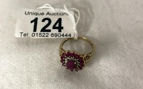 A yellow gold ruby and diamond ring, size P.