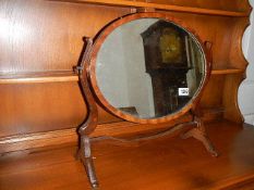 An oval mahogany toilet mirror.