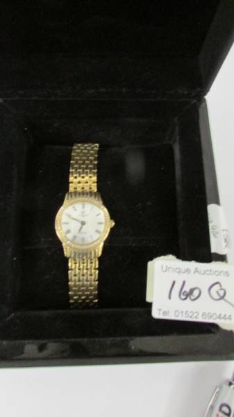 A boxed gold plated Christopher Ward Swiss made women's wrist watch with diamonds.